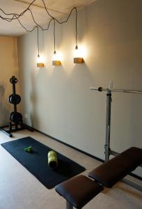 a room with a gym with two lights on the wall at Talbach Apartments in Buchen