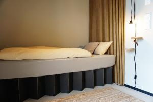 a bed with white sheets and pillows on it at Talbach Apartments in Buchen