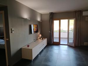 a bathroom with a sink and a large window at Suite Apartment Domus Cosenza in Cosenza