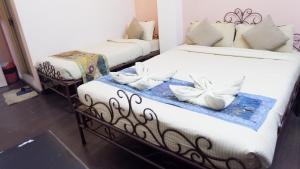 two beds in a room with white pillows on them at Cosy Hotel in Bhaktapur