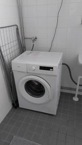 a washing machine in a bathroom with a washer at Apartment in Kauhajoki, Yrjöntie 5 in Kauhajoki