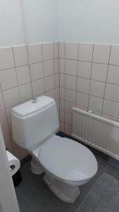 a bathroom with a white toilet and a tub at Apartment in Kauhajoki, Yrjöntie 5 in Kauhajoki