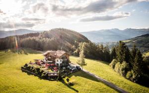 eine Luftansicht eines großen Hauses auf einem Feld in der Unterkunft Alpin Boutique Villa Gabriela - Adults Only in Kastelruth