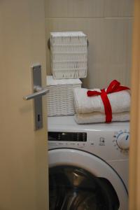 a washing machine with towels on top of it at Apartments Bepina in Split