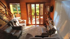 a living room with couches and a sliding glass door at Casas Ana in Canela