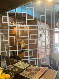 a dining room with a table and a wall of books at Surfer's Cafe& Hostel in Chatan