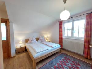 a small bedroom with a bed and a window at Lovely house with mountain view & big garden in Bad Aussee in Bad Aussee