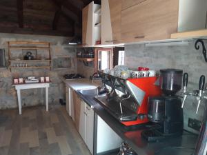 a kitchen with a red mixer on a counter at Kamping Luke in Trebinje
