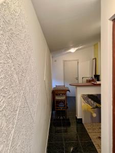 a hallway with a white wall with a table at Sanja apartment in Prčanj