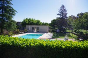 a swimming pool in the backyard of a house at Les Demeures du Clos in Niozelles