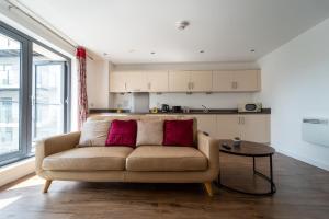 a living room with a couch and a table at Spacious Apartment in Woking Town Centre in Woking