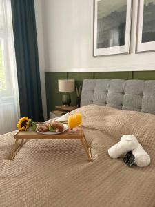 Una cama con una bandeja de comida. en Apartment 5 min Schönbrunn Gloriette, Direct to City Center, Free Parking, en Viena