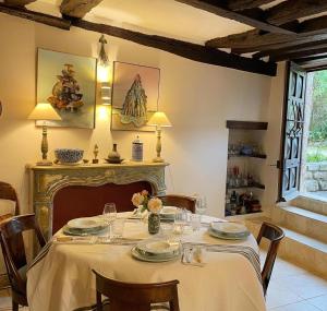 a dining room with a table with a white table cloth at EVERGREEN GuestHouse in Vernon