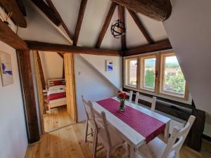 a dining room with a purple table and chairs at Apartmány Nad Kostolom in Betliar