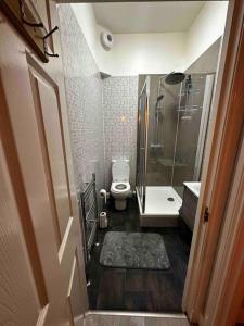 a small bathroom with a shower and a toilet at Victoria’s Dream in Aberdeen