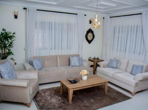 a living room with two couches and a coffee table at Blueberry Villas in Eldoret