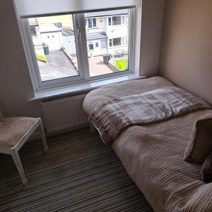 a bedroom with a bed and a large window at Oakworth in Oakworth