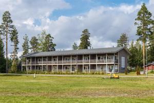 ein großes Gebäude mit einem Grasfeld davor in der Unterkunft Punkaharju Resort in Punkaharju