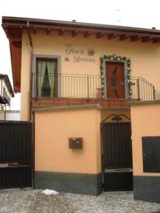 a house with a gate and a building with a door at B&B I fiori di Marianna in Bergamo