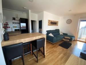 a living room with a couch and a table at 2 Terraces Apartment in Urban Villa - MLII in Varaždin