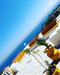 a yellow fire hydrant sitting next to the ocean at Villa Belle-Vue in Tabarka