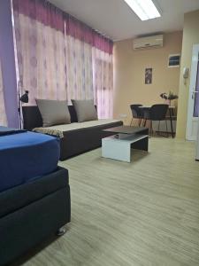 a living room with a couch and a table at LENI apartman u centru Zajecara in Zaječar