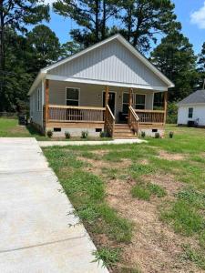 a small house with a porch and a large yard at New Cozy home: Near Stadium in Columbia