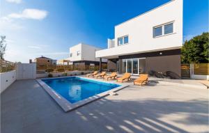 a swimming pool in the backyard of a house at Villa Valentina in Pag