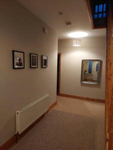 a hallway with a mirror on a wall at Home in Ennis in Ennis