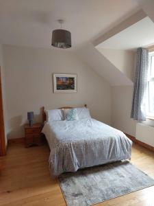 a white bedroom with a bed and a rug at Home in Ennis in Ennis