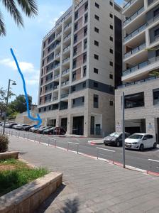 un aquilone blu che vola di fronte a un edificio di NEW! Great Location! Vibrant Downtown, Talpiot Market, Flea Market, Carmel Beach, close to everywhere a Haifa