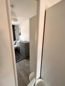 a mirror in a room with a bedroom at Double and single rooms in Bromley by bow in London
