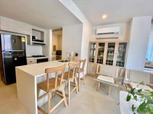 a kitchen with a table and chairs in a kitchen at Morros Zoe - Beautiful Apartment on Manzanillo Beach in Cartagena de Indias