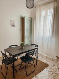 a dining room table with chairs and a potted plant on it at 10 MAGGIO APARTMENTS in Augusta