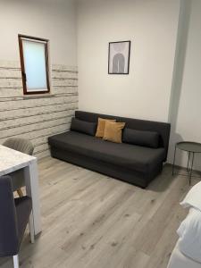 czarna kanapa w salonie z lustrem w obiekcie Aspen Studio Apartment + FREE Parking w Lublanie