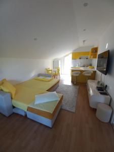 a bedroom with a large bed and a kitchen with a table at Vila Nastovski in Veles