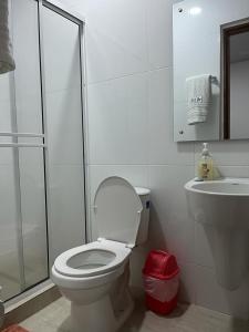 uma casa de banho branca com um WC e um lavatório em CASA DEL PARQUE Hotel 