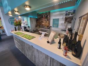 a kitchen with a counter with bottles of wine at Beach Hotel Torbay B&B in Paignton