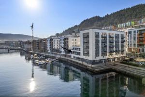 una ciudad con edificios y barcos en el agua en Dinbnb Apartments I Luxury with Views & Parking en Bergen