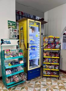 a yellow refrigerator with its door open and food inside at Hotel Los Balcones in Tocaima
