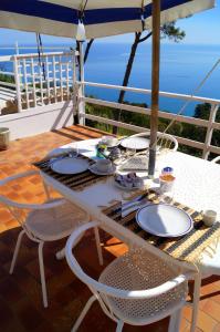 a table with plates of food on a balcony at Sea View Sirolo di Amedeo in Sirolo