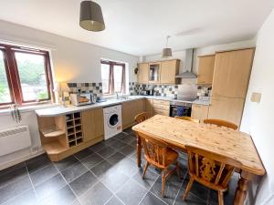 a large kitchen with a wooden table and chairs at Spacious, central and newly decorated apartment in Edinburgh