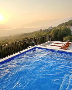 a swimming pool on a balcony with a view at Apartments HAS in Kotor