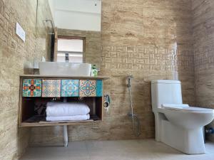 a bathroom with a sink and a toilet at Sangto Green Guest House in Leh
