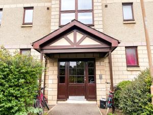 a house with a brown door at Spacious, central and newly decorated apartment in Edinburgh