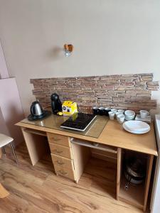 a wooden table with a counter with a brick wall at U Piekarza za Piecem in Głuchołazy