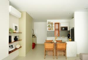 a kitchen and dining room with a table and chairs at Velea@Rose Apple Square in Siem Reap