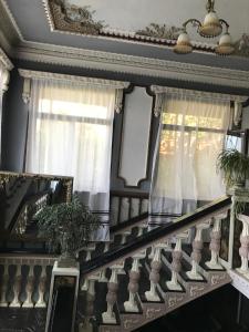 a staircase with white railings and a window at Irma in Sighnaghi