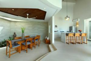 a kitchen and dining room with a table and chairs at Villa KMEA 4 in Seminyak