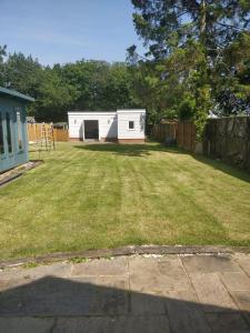 a yard with a shed in the background at 4 bed private home in Colchester in Colchester